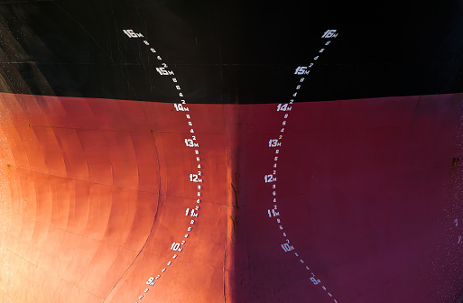 The bow of a large tanker ship with the indicated diving depth on it, front view.