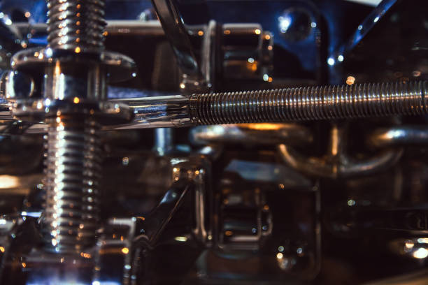 Steel threaded structure with rods, close-up in dark colors.