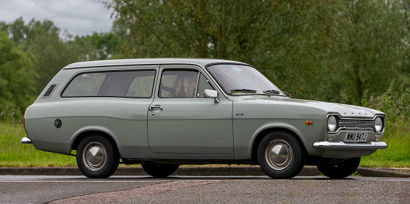 Stony Stratford, Bucks, UK. June 5th 2022. 1971 Ford Escort estate driving on an English country road