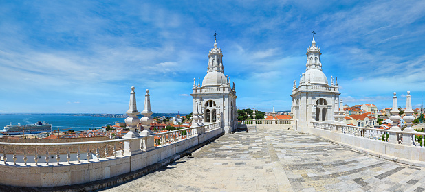 Roof with white bell towers on blue sky background. Monastery of St. Vincent Outside the Walls, or Church (Iglesia) de Sao Vicente de Fora in Lisbon, Portugal.