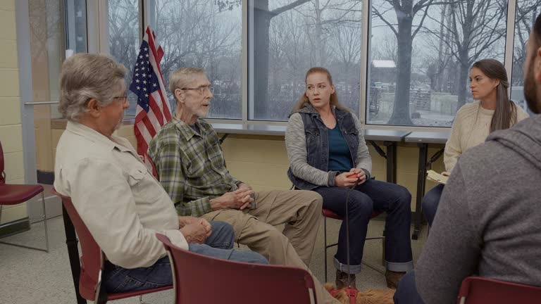 A mixed age group of veterans participate in support group meeting