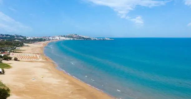 Summer Lido di Portonuovo Adriatic sea beach view (Vieste, Gargano peninsula, Puglia, Italy). People are unrecognizable. Two shots stitch panorama.