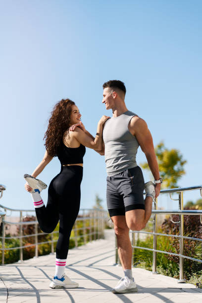 istock Couple stretching outdoors before morning run 1471030563