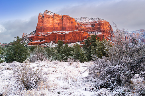 Winding road through the red rocks and scenic high desert landscape with snow in Sedona, Arizona.
