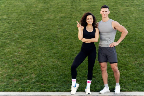 istock Positive sportive people standing over grass background 1471031729