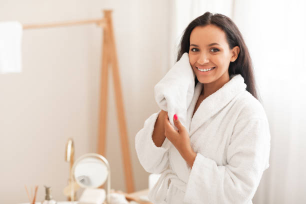istock Lady Drying Face With Towel Caring For Skin In Bathroom 1471032150