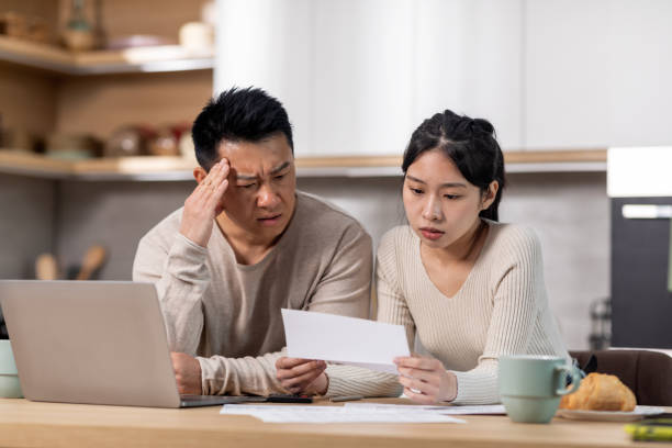 istock Upset korean husband and wife reading letter, kitchen interior 1471032180