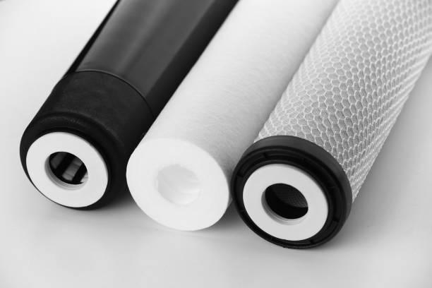 istock Cropped three filter cartridges for house water filtration system isolated. Foamed polypropylene, granular and briquettes carbon cartridges. Installation of reverse osmosis water purification system 1471032401