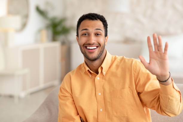 istock Greeting Concept. Arab man waving hand at camera 1471033573