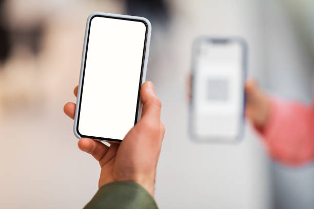 istock Male Hand Holding Cellphone Scanning Code On Phone Indoors, Closeup 1471033601