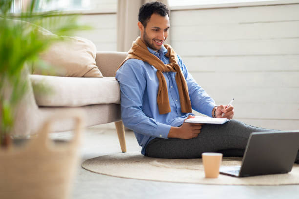 istock Portrait of smiling Arab man using laptop and writing 1471033948