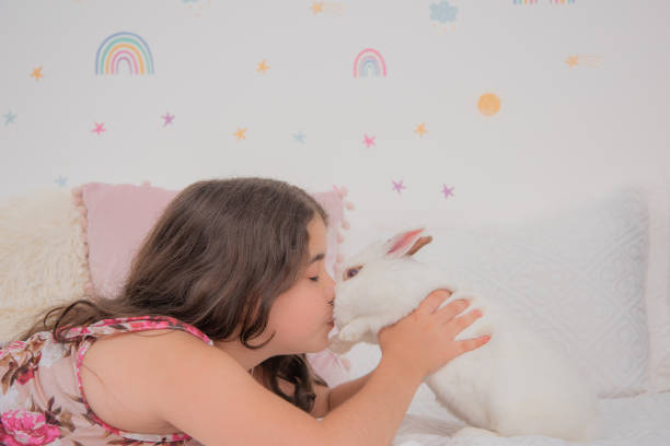 Girl lying down with white rabbit