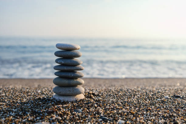 istock Balanced pebble pyramid silhouette on the beach 1471039772