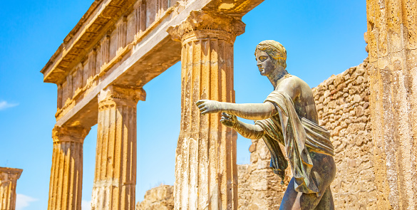 Ancient Pompeii city skyline and bronze Apollo statue, Italy travel photo