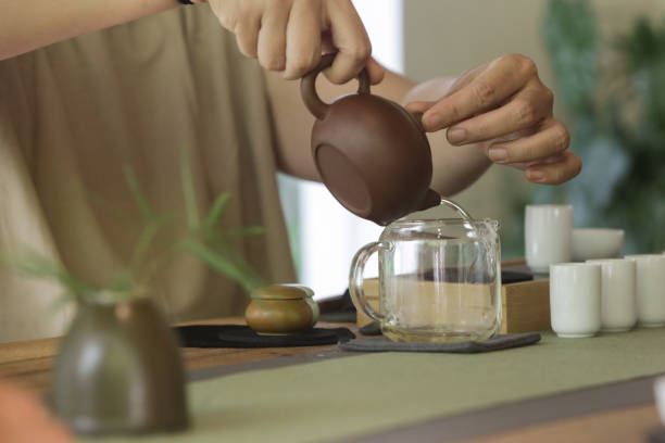 istock Chinese Tea Ceremony experience. Exquisite hot tea at traditional Chinese Tea Ceremony. Group of women participating in a traditional tea ceremony class, serie of photos. 1471042319
