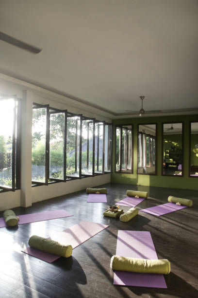 istock Blissful meditation studios to stop and feel zen. Empty yoga studio, mats, pillows and accessories, spacious meditation room 1471043832