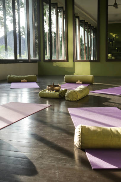 istock Blissful meditation studios to stop and feel zen. Empty yoga studio, mats, pillows and accessories, spacious meditation room 1471044247