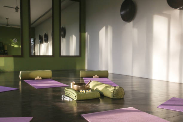 istock Blissful meditation studios to stop and feel zen. Empty yoga studio, mats, pillows and accessories, spacious meditation room 1471045066