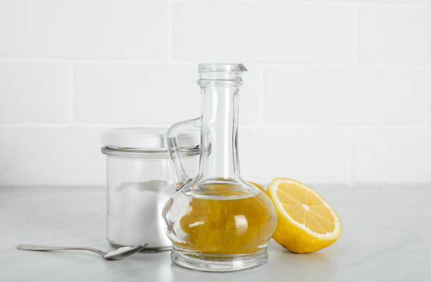 istock Vinegar, baking soda and lemon on white marble table. Eco friendly natural detergents 1471046758
