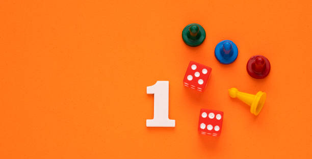 istock Number 1 with dice and board game pieces - Orange eva rubber background 1471049756