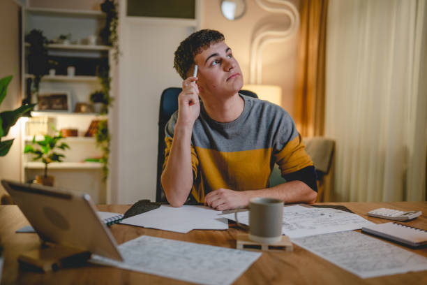 istock Young caucasian man teenager student study at home at the table night 1471053076