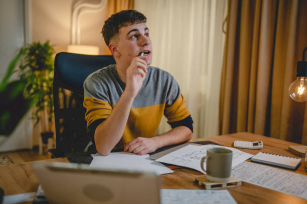 istock Young caucasian man teenager student study at home at the table night 1471053077