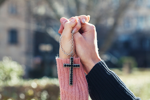 Hands holding a Christian cross