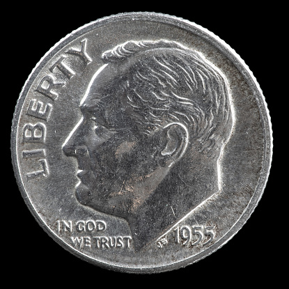 1955 silver Roosevelt US dime on black background.