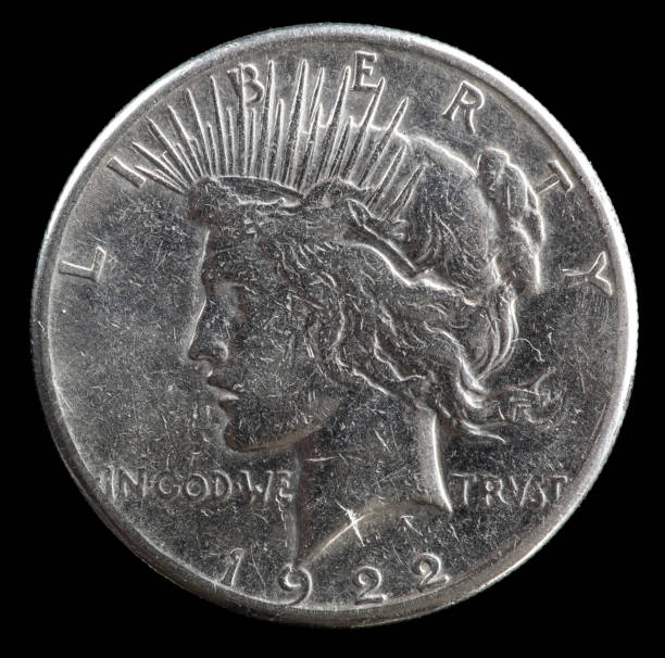 istock 1922 silver US Peace Dollar on black background. 1471059612