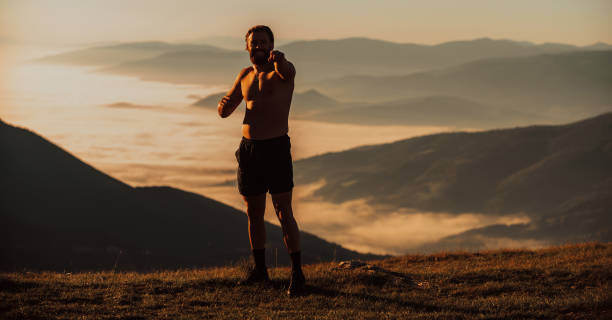 istock An athlete rests on top of a mountain after exhausting running training. 1471060871