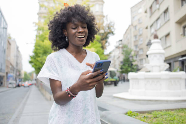 istock Happy young woman using phone 1471065850
