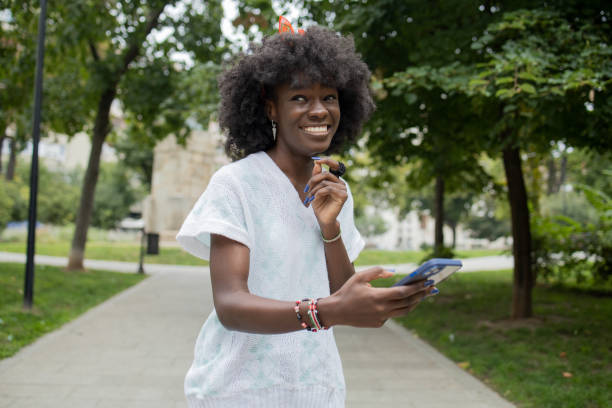 istock Happy young woman using phone 1471065880