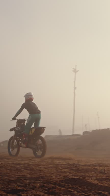 Sports, skills and man riding a motorbike on a dirt road training for a competition or race. Fitness, extreme sport and male biker athlete practicing a trick on a motorcycle outdoor in the desert.