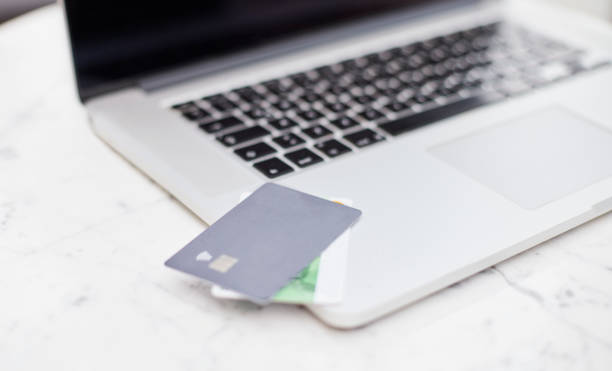 istock Credit cards standing on a laptop. 1471073575