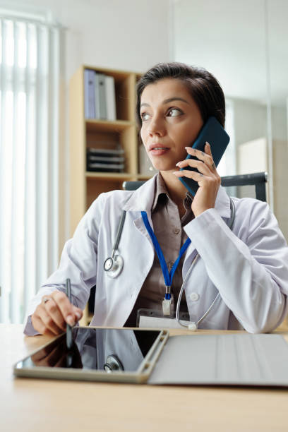 istock Doctor Talking on Phone 1471075987