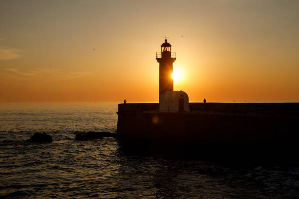istock Silhouette of an old lighthouse during the sunset. 1471080670
