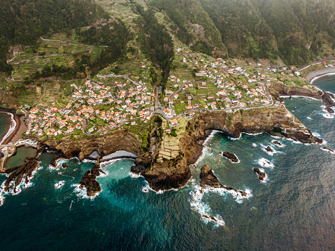 Madeira beautiful coastline. Drone view of seashore and island village