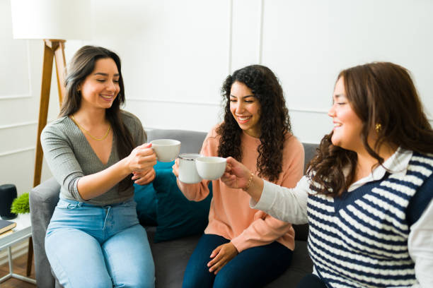 istock Smiling cheerful best friends drinking coffee or tea 1471084180