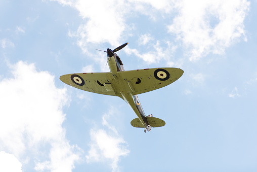 Cambridge, UK – Sept 12, 2015: A Supermarine Spitfire from Duxford museum flies through the skies over Cambridge as part of the annual dragon boat race