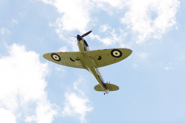 RAF Supermarine Spitfire WW2 fighter plane flying in the sky over Cambridge UK Cambridge, UK – Sept 12, 2015: A Supermarine Spitfire from Duxford museum flies through the skies over Cambridge as part of the annual dragon boat race spitfire stock pictures, royalty-free photos & images