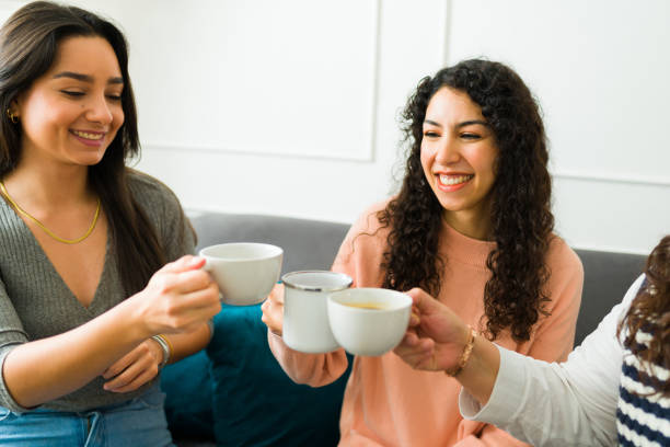 istock Happy female friends drinking coffee together 1471084192