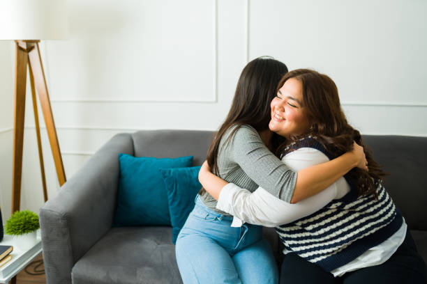 istock Cheerful female friends embracing and smiling 1471084352
