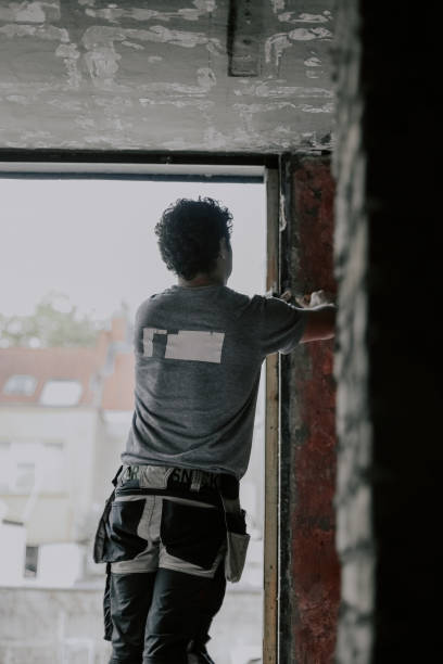 istock Caucasian male builder clean the window opening. 1471085587