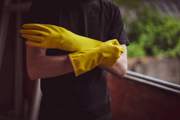 istock Caucasian male builder wears yellow gloves. 1471085618