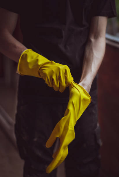 istock Caucasian male builder wears yellow gloves. 1471085620