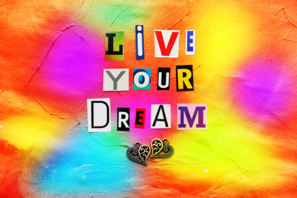 istock Live your Dream paper cut letters on abstract  gouache  paint texture on canvas with embossed , orange coral paint strokes. Hand drawn gouache  painting. 1471086030