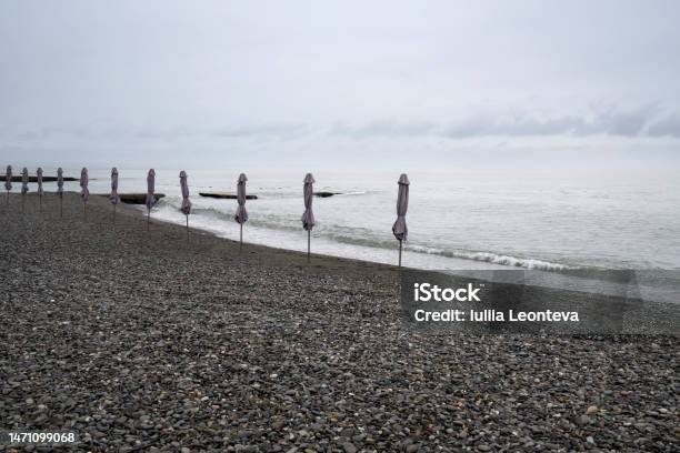 Deserted Beach On The Black Sea Coast Of Sochi Against The Cloudy Sky Adler Krasnodar Territory Russia Stock Photo - Download Image Now