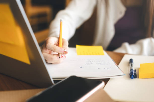istock No face closeup hand young adult women writing note for study and work 1471099171