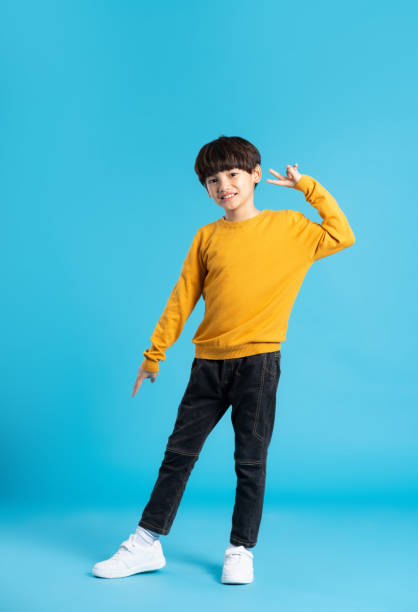 istock full body image of asian boy posing on blue background 1471103347