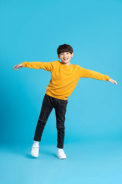 istock full body image of asian boy posing on blue background 1471103348